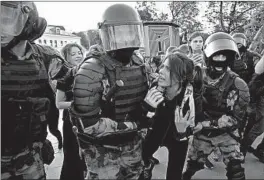  ?? ALEXANDER ZEMLIANICH­ENKO/AP ?? Russian police officers clash with protesters Saturday in central Moscow. Protesters are demanding that opposition candidates be allowed to run for the Moscow City Council.