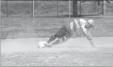  ??  ?? Mark Janes slides into first base during the final game of the Windsor Royals Coed Slo-Pitch tournament on Aug. 12.