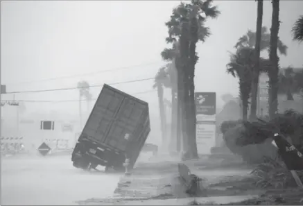  ?? COURTNEY SACCO, CORPUS CHRISTI CALLER-TIMES, THE ASSOCIATED PRESS ?? Winds whipping over 130 m.p.h. topple a truck in Corpus Christi near the heart of hurricane Harvey, which made land at about 10 p.m. Friday.