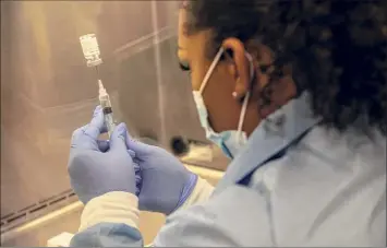  ?? Adriana Zehbrauska­s / New York Times ?? A pharmacist in Chandler, Ariz. prepares an injection during a trial for Regeneron’s antibody treatment, Aug. 12. The Food and Drug Administra­tion has granted emergency authorizat­ion of the COVID-19 antibody treatment made by Eli Lilly that is similar to a therapy given to President Donald Trump shortly after he contracted the coronaviru­s.