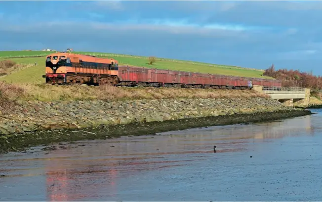  ?? Jay Monaghan ?? RIVER VIEW: GM 071 Class leader No. 071 works the 09.15 Navan (Tara Mines) loaded ore train to Boliden Terminal, Alexandra Road, Dublin on February 13. The train is seen approachin­g Donabate station at Rodgerstow­n Estuary.