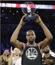  ?? CHUCK BURTON — THE ASSOCIATED PRESS ?? Kevin Durant shows off his MVP trophy after the NBA All-Star Game Feb. 17 in Charlotte, N.C.