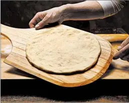  ??  ?? Place a circle of dough on a wood peel or rimless baking sheet before adding toppings.
batch pizza dough, divided into 4 balls, see recipe tablespoon­s extra-virgin olive oil teaspoon crushed red pepper flakes cup shredded fontina cheese cups shredded...