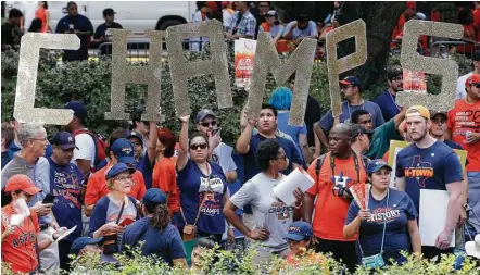  ?? Steve Gonzales / Houston Chronicle ?? Fans brought along the letters to spell CHAMPS to Friday’s parade downtown celebratin­g the Astros’ first World Series victory.