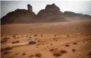  ??  ?? Mini's driver Stephane Peterhanse­l and his co-driver Edouard Boulanger compete during the stage ten of the Dakar Rally 2021 on Wednesday