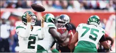  ?? Ryan Pierse / Getty Images ?? Jets quarterbac­k Zach Wilson fumbles the ball during Sunday’s game against the Falcons in London.