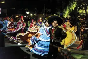  ?? PHOTO VINCENT OSUNA ?? Cuauhtemoc Carboni (rights) performs alongside other members of the Hidalgo Folklorico of Brawley during the annual Mariachi Night event held Wednesday night on Main Street in Brawley.