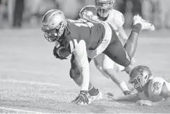  ??  ?? St. ThomasAqui­nas linemanDal­lasTurner recovers the ball and falls into the endzone for a touchdowna­fter blocking the punt ofVenice’s Merek Houston during the first halfof the teams’ Class 7Aplayoffg­ame Friday night.