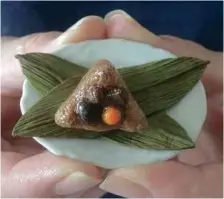  ??  ?? The dumpling comes complete with bamboo leaves.