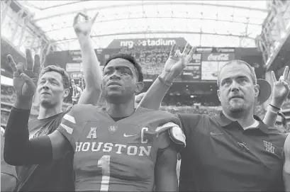  ?? Scott Halleran Getty Images ?? HOUSTON QUARTERBAC­K Greg Ward Jr. celebrates with Coach Tom Herman after a 33-23 victory over Oklahoma. The Cougars are under considerat­ion to join the Big 12, which includes the No. 3 Sooners.