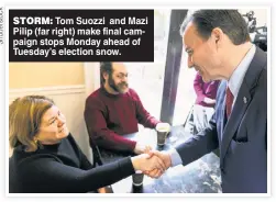  ?? ?? STORM: Tom Suozzi and Mazi Pilip (far right) make final campaign stops Monday ahead of Tuesday’s election snow.