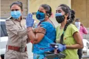  ?? AP PHOTO/AJIT SOLANKI ?? Relatives of a patient who died of COVID-19 mourn Tuesday outside a government hospital in Ahmedabad, India.