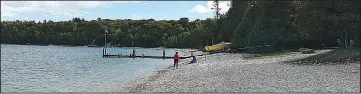  ?? Chicago Tribune/TNS/KURT CHANDLER ?? Countless limestone rocks line Schoolhous­e Beach along the waters of Washington Harbor. Visitors caught removing the rocks face a stiff fine.