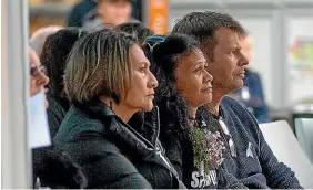  ?? WARWICK SMITH/STUFF ?? Brenda Reuben, centre, and her partner Robert O’Shea listen to the speakers ahead of a candlelit vigil for her daughter Jasmine Wilson in Majestic Square, Whanganui.