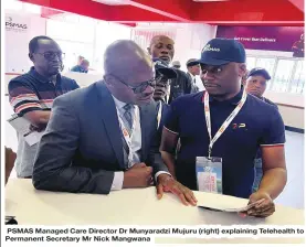  ?? ?? PSMAS Managed Care Director Dr Munyaradzi Mujuru (right) explaining Telehealth to Permanent Secretary Mr Nick Mangwana