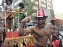  ??  ?? A LA BRAZIL: Guys show off their muscles as they pull a float.