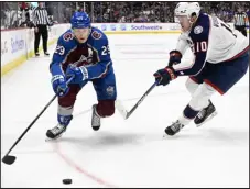 ?? ?? Avalanche center Nathan Mackinnon chases down the puck against Columbus Blue Jackets left wing Dmitri Voronkov in the third period at Ball Arena on March 22.