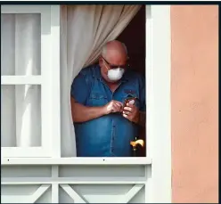  ??  ?? STUCK INDOORS: Another Tenerife tourist at his hotel window