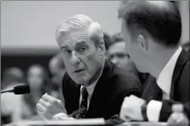  ?? ASSOCIATED PRESS ?? FORMER SPECIAL COUNSEL ROBERT MUELLER, accompanie­d by his top aide in the investigat­ion Aaron Zebley, testifies before the House Intelligen­ce Committee hearing on his report on Russian election interferen­ce on Capitol Hil in Washington on Wednesday.