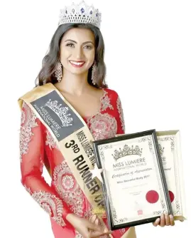  ??  ?? Ashwini Maharaj with her certificat­es from the Miss Lumiere Internatio­nal World Pageant.