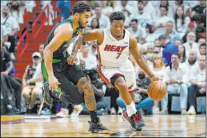  ?? Lynne Sladky The Associated Press ?? Heat guard Kyle Lowry drives against Celtics forward Jayson Tatum in Game 5. The Heat are in must-win mode in Friday’s Game 6.