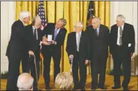  ?? The Associated Press ?? TRADITION: President Bush, third from left, presents the 2007 National Humanities Medal to members of the Monuments Men Foundation, from left, Robert Edsel, Jim Reeds, Harry Ettlinger, Horace Apgar and Seymore Pomrenze, for the Preservati­on of Art of...