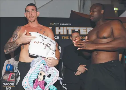  ?? Picture: GETTY IMAGES ?? Demsey McKean (left) last night hands Jonathan Rice a pink handbag in another jab ahead of their fight.