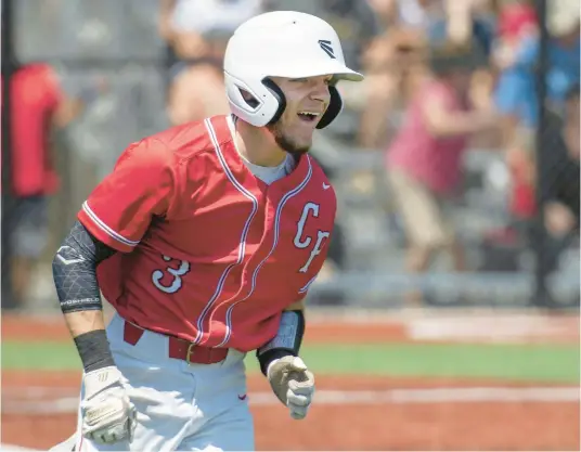  ?? MICHAEL GARD/ POST-TRIBUNE ?? Crown Point’s Matt Corona smiles as he rounds the bases after hitting a home run against Hobart during Monday’s Class 4A Valparaiso Sectional championsh­ip game.
