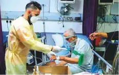  ?? AP ?? ■ A coronaviru­s patient being treated at a hospital in Najaf. Infections in Iraq have surged to record highs in a third wave.