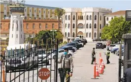  ?? ERIC RISBERG APFILE ?? An officer closes the main gate at San Quentin State Prison. A lawsuit alleges California’s correction­s agency routinely refers certain inmates to ICE.