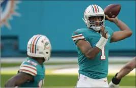  ?? CHRIS O’MEARA — THE ASSOCIATED PRESS ?? Miami Dolphins quarterbac­k Tua Tagovailoa (1) attempts to throw a pass, during the second half against the New England Patriots, Sunday, in Miami Gardens, Fla.