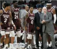  ?? ROGELIO V. SOLIS — THE ASSOCIATED PRESS ?? Mississipp­i State head coach Ben Howland, right, and his players ready themselves to enter the floor following a time out against Mississipp­i in the first half of an NCAA college basketball game, Saturday in Starkville, Miss. Mississipp­i won 81-77.