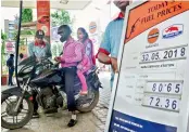  ?? — PTI ?? An employee attends a customer at a petrol pump in Guwahati on Wednesday.