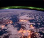  ??  ?? Right: The northern lights seen dancing above Earth from the ISS