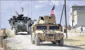  ?? ARAB 24 NETWORK ?? A U.S. convoy rolls through the outskirts of Manbij, Syria, on Tuesday. A U.S. military official said the Marine contingent just arrived will not serve on the front line but provide artillery support to Kurdish-led forces as they advance on Raqqa, Syria.