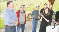  ??  ?? Bysiewicz, right, holds one of the Passport booklets as she speaks about the Passport to Connecticu­t Wineries in Shelton on Friday. Behind Bysiewicz, from left, are Jonathan Edwards, president of the Connecticu­t Vineyard and Winery Associatio­n; Terry Jones and his son, Jamie Jones, of Jones Family Farms; Hurlburt; and O’Neill.