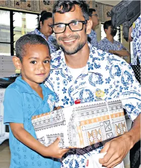  ?? Photo: Vilimoni Vaganalau ?? Eparama Boso with a smile after receives his Christmas gift from Darren Manuel during the China Railway First Group (Fiji) Company Limited visit to Dilkusha Home on December 14, 2017.