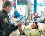  ?? BROWARD COUNTY SHERIFF'S OFFICE/COURTESY ?? Broward County Sheriff Scott Israel visits Anthony Borges, 15, last month. Borges and his parents plan to file suit.