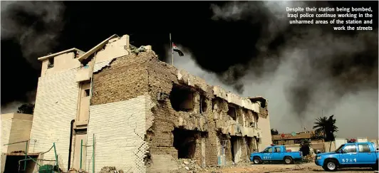  ??  ?? Despite their station being bombed, Iraqi police continue working in the unharmed areas of the station and
work the streets