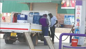  ?? Picture by Tawanda Mudimu ?? A motorist fills drums at Flow Service Station along Bulawayo Road recently. —
