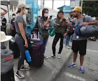  ?? Associated Press ?? ■ Tourists from the United States wait Friday outside Peru’s closed Jorge Chavez Internatio­nal Airport for a member of the U.S. Embassy to escort them to a flight that will fly them back to the U.S.