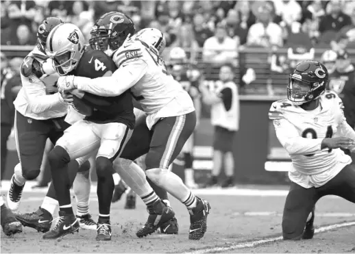  ?? DAVID BECKER/AP ?? Bears outside linebacker Khalil Mack sacks Raiders quarterbac­k Derek Carr during the first half Sunday in Las Vegas.