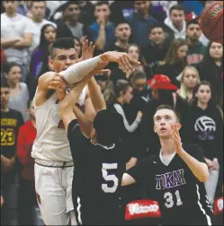  ?? DAVID WITTE/NEWS-SENTINEL ?? Above: Lodi's Marcell Roberts (20) makes a pass through the Tokay defense during their game on Friday at The Inferno. Below: Tokay's Mohammad Ibrahim (11) meets the defense of Lodi's Marcell Roberts, right, and Matt Nickel (32).