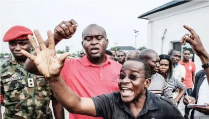  ?? Photo: AFP ?? Suspects who were arrested by Nigerian Army personnel on the election day in connection with alleged various electoral offenses, are gathered before being handed over to the police at the Nigerian Army’s Bori camp in Port Harcourt yesterday