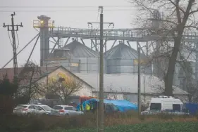  ?? AP PHOTO/MICHAL DYJUK ?? Police officers work outside a grain depot Wednesday where, according to the Polish government, an explosion of a Russian-made missile killed two people in Przewodow, Poland.