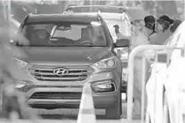  ?? AMY BETH BENNETT/SOUTH FLORIDA SUN SENTINEL ?? Alex Pierce is swabbed during drive-thru testing for the new coronaviru­s at Cleveland Clinic Weston’s Krupa Center on Thursday.