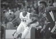  ?? NWA Democrat-Gazette/BEN GOFF ?? Manny Watkins (21) of Arkansas drives past Kevon Harris (1) of Stephen F. Austin in the Razorbacks’ 78-62 victory Thursday night at Walton Arena in Fayettevil­le. Watkins scored eight points in 21 minutes, helping the Razorbacks improve to 5-1 on the...