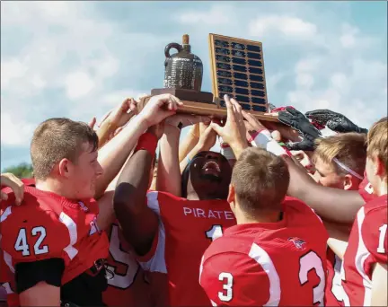  ?? COLEEN MOSKOWITZ — FOR THE NEWS-HERALD ?? Perry celebrates with the Little Brown Jug trophy after defeating Madison on Sept. 14.