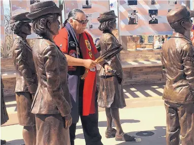  ?? ANGELA KOCHERGA/JOURNAL ?? Edward Santa Cruz with the Eagle Claw Warrior Society blesses the monument to women veterans during a dedication ceremony Saturday in Las Cruces.