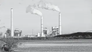  ?? Staff file photo ?? CPS Energy coal-fired power plants J.K. Spruce, middle and right stacks, and Deely, now retired, are shown. The Spruce plant is one of the biggest contributo­rs to San Antonio’s carbon footprint.